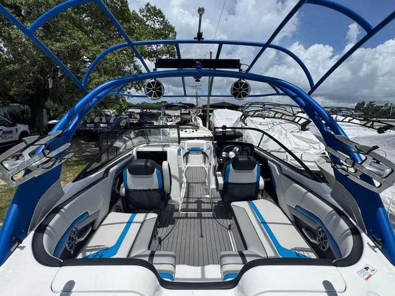 Slide: The Image of 2018 Yamaha Boats 242X E-Series interior with blue accents and spacious seating. - 6