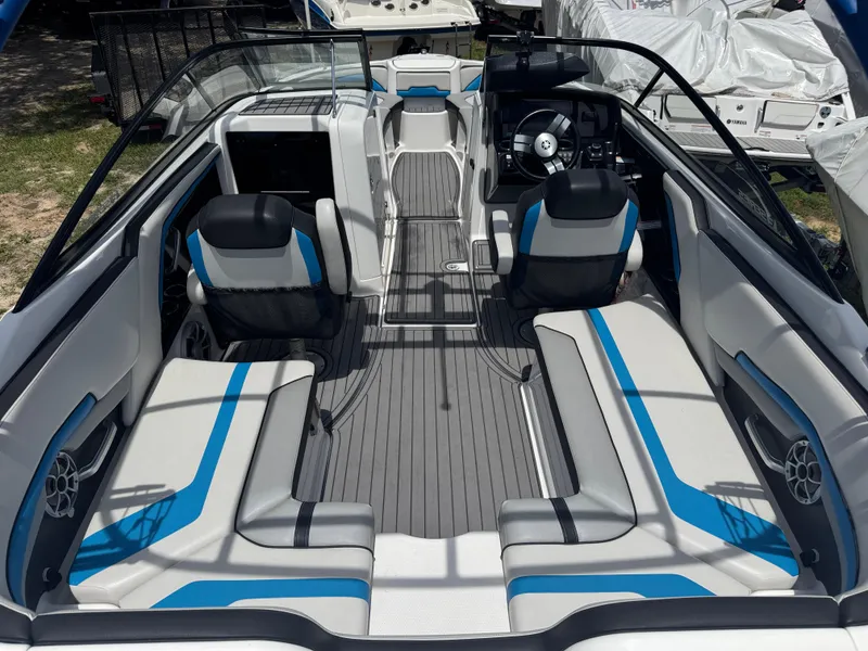 Slide: The Image of 2018 Yamaha Boats 242X E-Series interior with sleek seating and modern dashboard. - 7