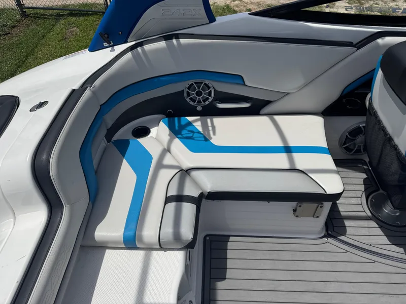 Slide: The Image of 2018 Yamaha Boats 242X E-Series interior with blue-accented seating and speaker. - 8