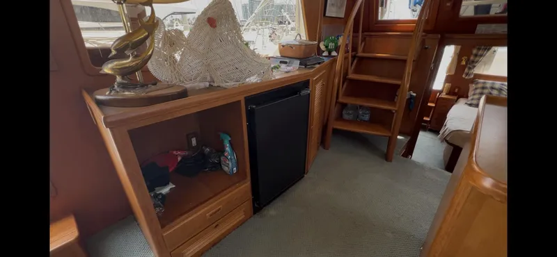 Slide: The Image of Interior of 1988 Offshore Yachts 48 CPMY with wooden cabinetry and stairs. - 10