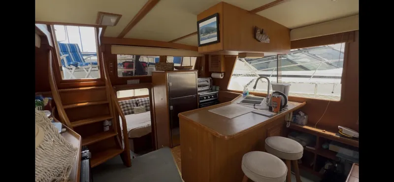 Slide: The Image of Interior of 1988 Offshore Yachts 48 CPMY, featuring kitchen and seating area. - 2
