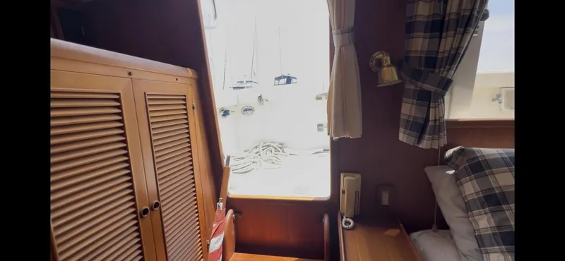 Slide: The Image of Cozy cabin interior of 1988 Offshore Yachts 48 CPMY with plaid decor and wooden furnishings. - 20