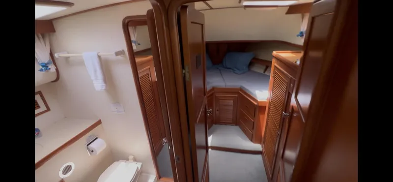 Slide: The Image of Interior of 1988 Offshore Yachts 48 CPMY, featuring a cozy cabin and bathroom. - 22