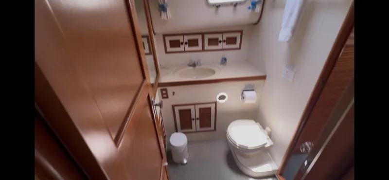 Slide: The Image of Bathroom interior of 1988 Offshore Yachts 48 CPMY, featuring sink and toilet. - 24