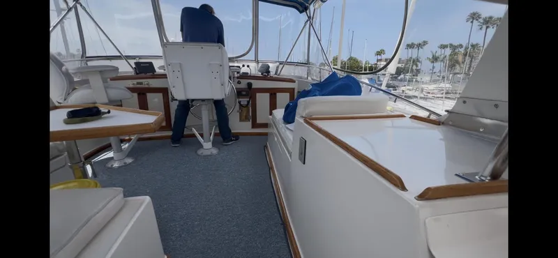 Slide: The Image of Interior view of 1988 Offshore Yachts 48 CPMY, featuring helm and seating area. - 29