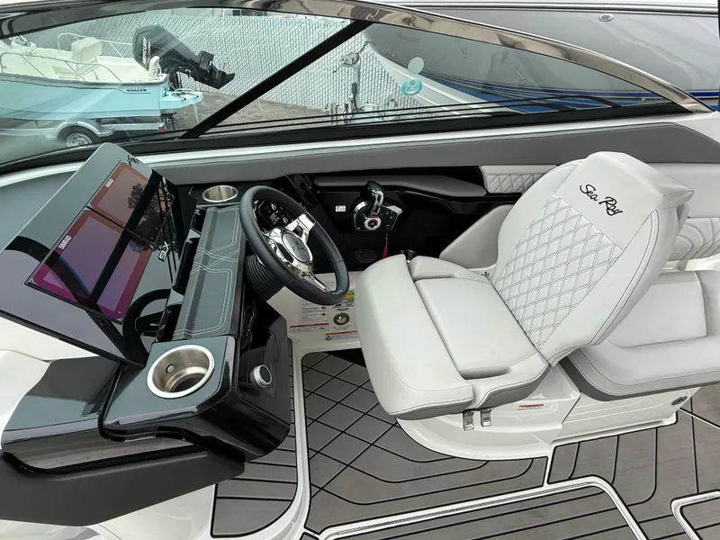 Slide: The Image of 2024 Sea Ray SLX 260 boat interior with modern dashboard and luxurious seating. - 13