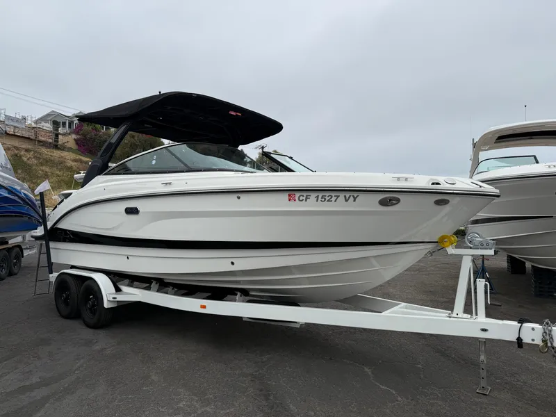 Slide: The Image of 2024 Sea Ray SLX 260 boat on trailer, parked outdoors. - 3