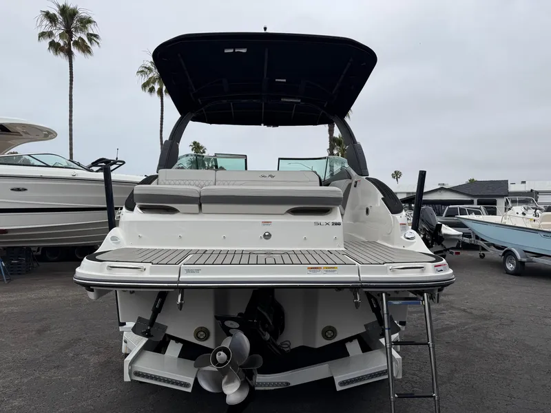 Slide: The Image of 2024 Sea Ray SLX 260 boat, rear view, docked with ladder and canopy. - 4