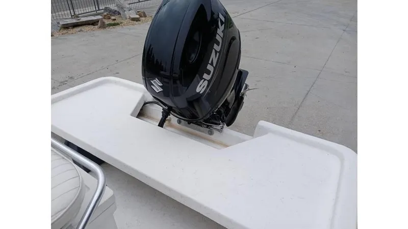 Slide: The Image of Outboard motor on a 2006 Mako 211 boat, featuring a Suzuki engine. - 3