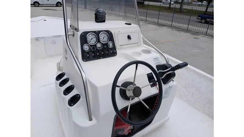 Slide: The Image of 2006 Mako 211 boat console with steering wheel and gauges. - 4