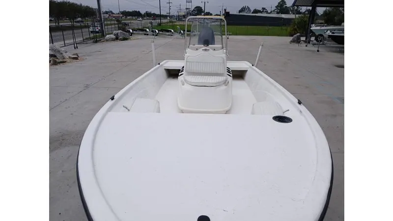 Slide: The Image of 2006 Mako 211 boat, white deck, center console, parked outdoors. - 7