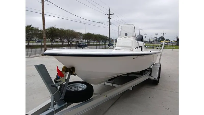 Slide: The Image of 2006 Mako 211 boat on trailer, parked outdoors, overcast sky. - 9