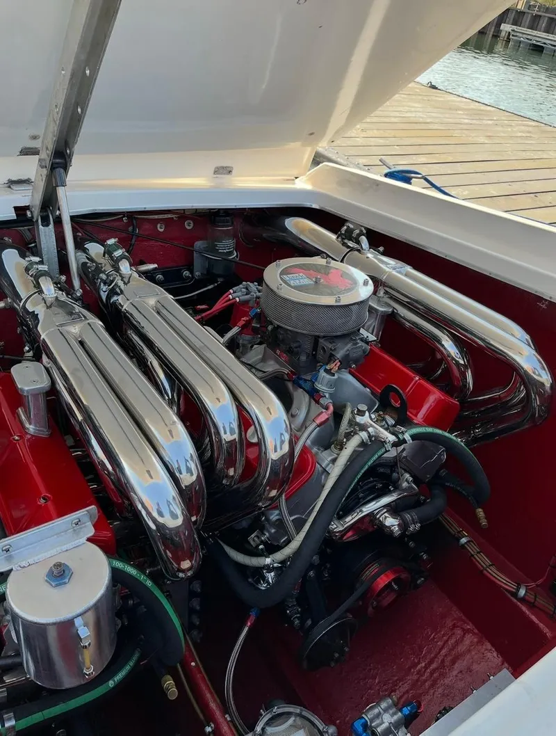 Slide: The Image of 1987 Cigarette 38 Top Gun engine with polished chrome components and red accents. - 10