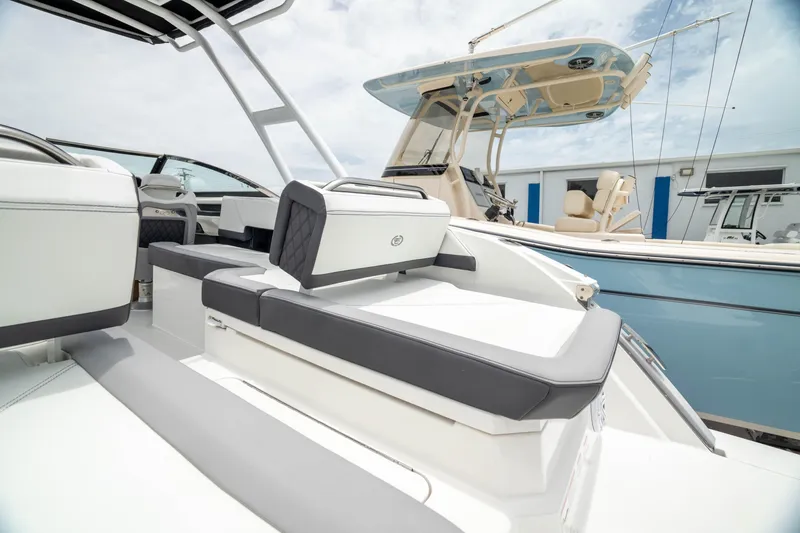 Slide: The Image of 2023 Cobalt R6 Outboard boat with sleek seating, docked at marina. - 12