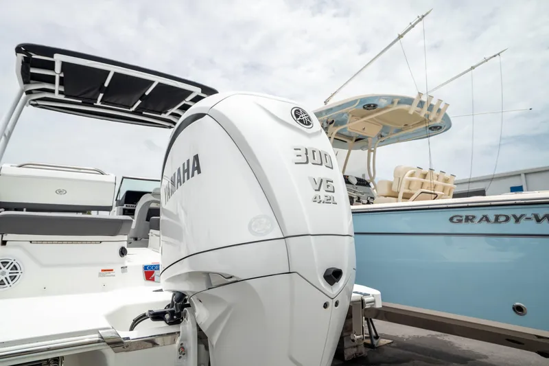 Slide: The Image of 2023 Cobalt R6 Outboard with Yamaha 300 V6 engine, docked beside a blue Grady-White boat. - 19