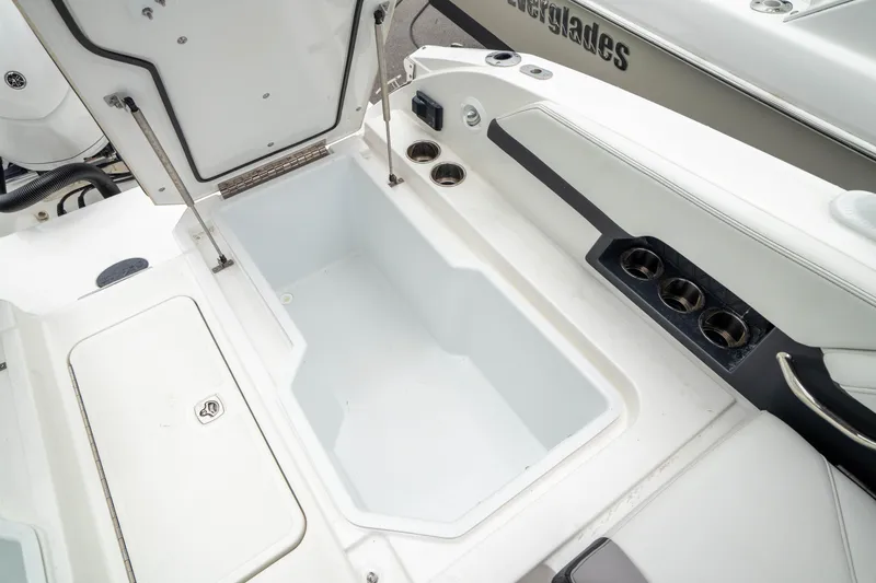 Slide: The Image of 2023 Cobalt R6 Outboard boat storage compartment with open lid, showcasing spacious interior. - 23