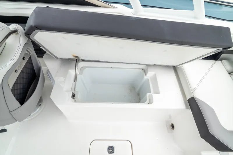 Slide: The Image of Open storage compartment on 2023 Cobalt R6 Outboard boat, showcasing seating and interior design. - 25