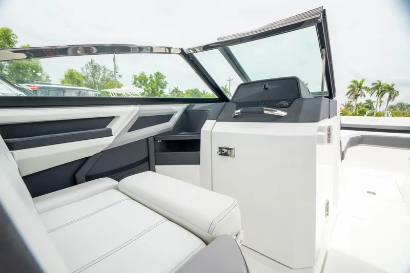 Slide: The Image of 2023 Cobalt R6 Outboard interior with sleek white seating and modern dashboard design. - 29