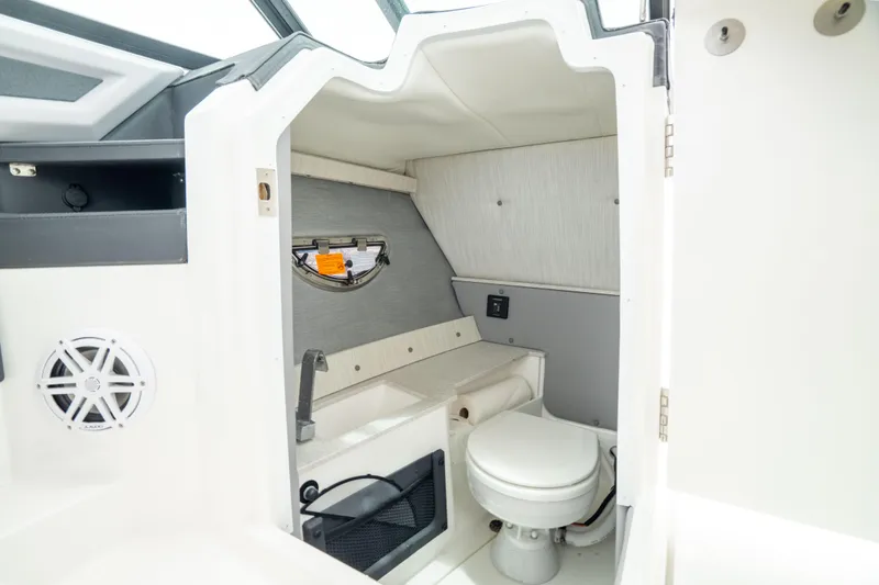 Slide: The Image of 2023 Cobalt R6 Outboard boat interior with compact bathroom and modern amenities. - 3