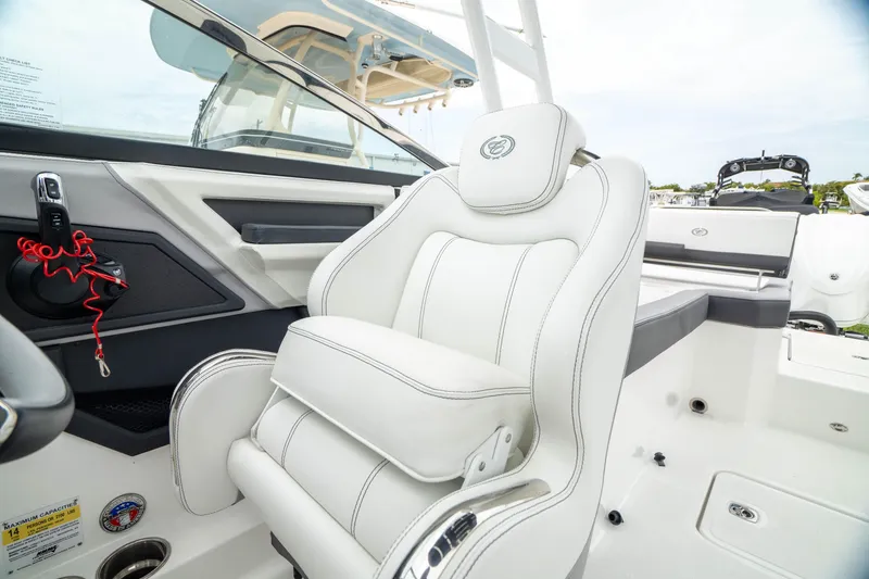 Slide: The Image of 2023 Cobalt R6 Outboard boat interior with luxurious white seating and modern design. - 32
