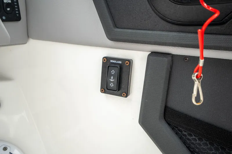 Slide: The Image of 2023 Cobalt R6 Outboard boat interior with windlass control panel and safety lanyard. - 34