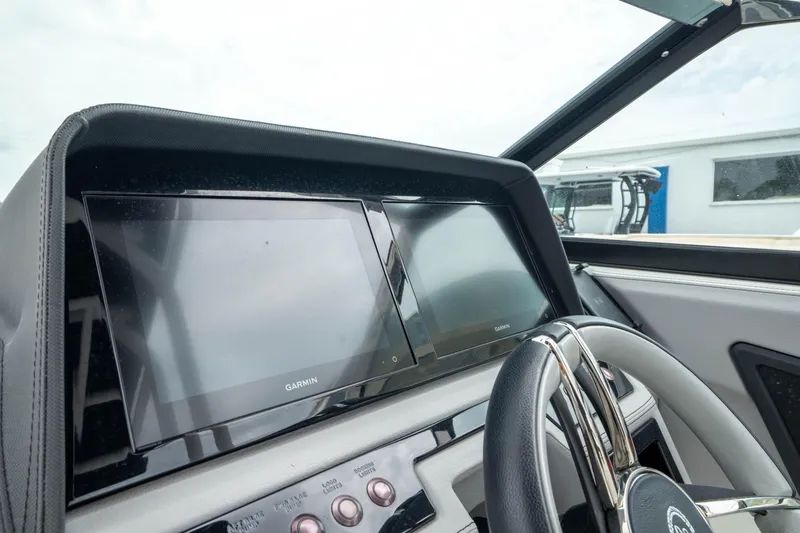 Slide: The Image of 2023 Cobalt R6 Outboard dashboard with Garmin display and steering wheel. - 36
