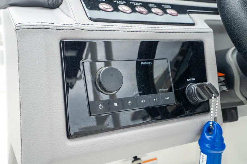 Slide: The Image of 2023 Cobalt R6 Outboard dashboard with Fusion audio system and ignition key. - 38