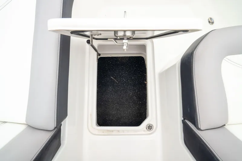 Slide: The Image of 2023 Cobalt R6 Outboard storage compartment with open lid, showcasing interior space. - 40
