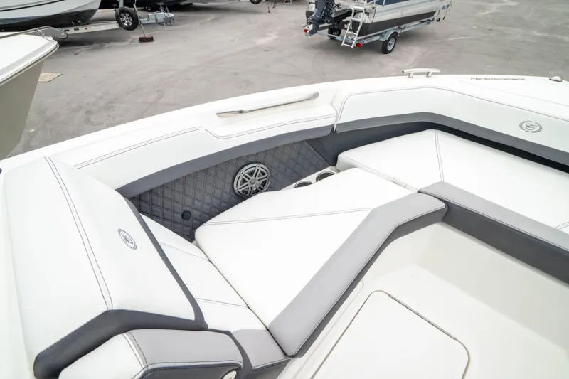 Slide: The Image of 2023 Cobalt R6 Outboard boat interior with white and gray seating, featuring a speaker. - 41