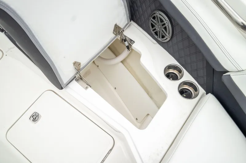 Slide: The Image of 2023 Cobalt R6 Outboard boat interior with open storage compartment and cup holders. - 42