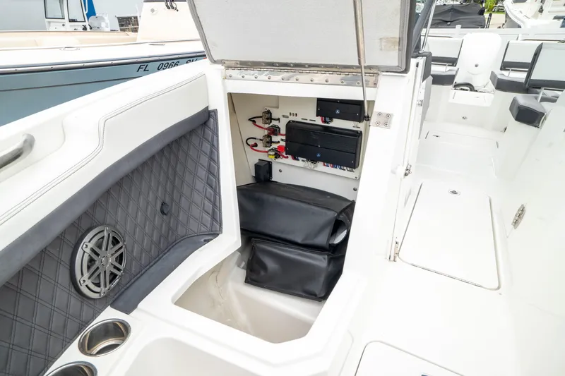 Slide: The Image of 2023 Cobalt R6 Outboard boat interior with storage compartment and speaker. - 43