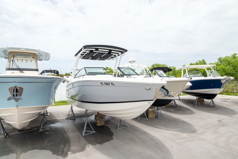 Slide: The Image of 2023 Cobalt R6 Outboard boat displayed on stands in a marina. - 47