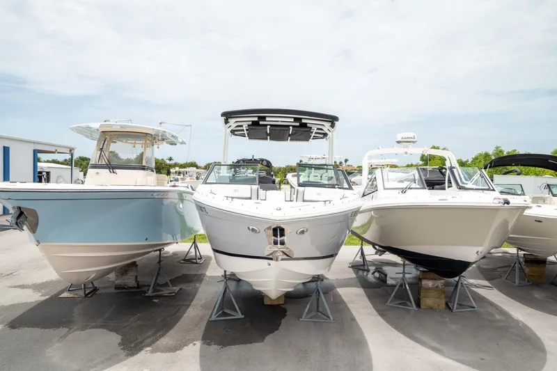 Slide: The Image of 2023 Cobalt R6 Outboard boat displayed among other boats in a marina. - 48