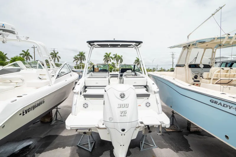 Slide: The Image of 2023 Cobalt R6 Outboard boat displayed between two other boats in a marina. - 6