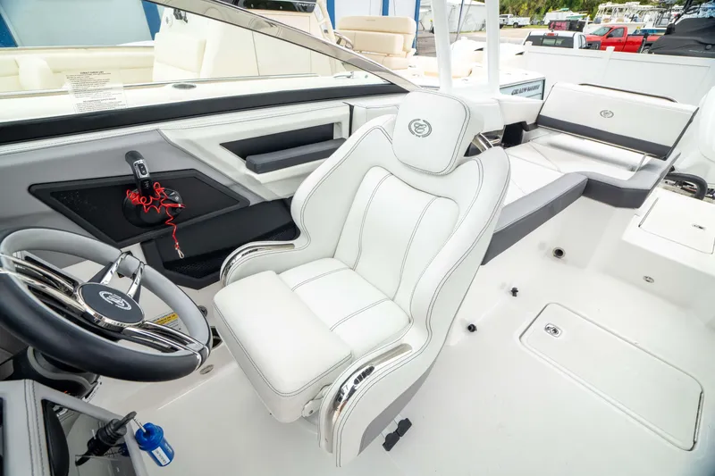 Slide: The Image of 2023 Cobalt R6 Outboard boat interior with white captain's seat and steering wheel. - 7