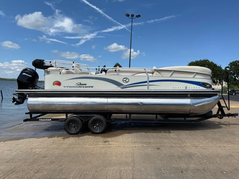 Slide: The Image of 2011 Sun Tracker Regency Party Barge 22 on trailer, rear view with outboard motor. - 16