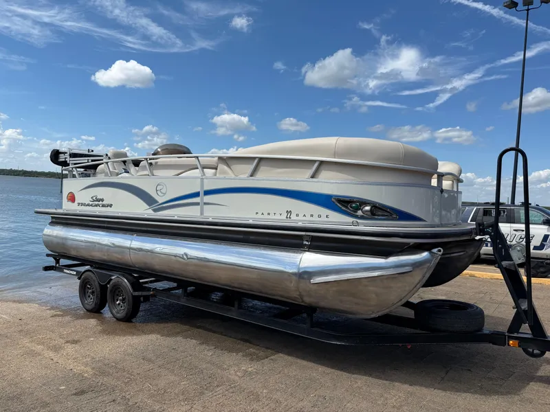 Slide: The Image of 2011 Sun Tracker Regency Party Barge 22 on trailer with Mercury outboard motor. - 18