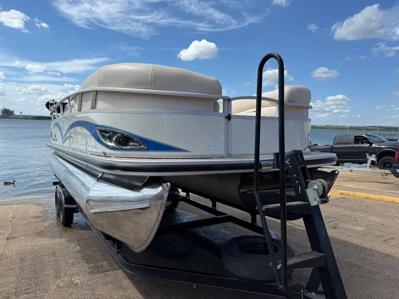 Slide: The Image of 2011 Sun Tracker Regency Party Barge 22 pontoon boat on trailer by a lake. - 20