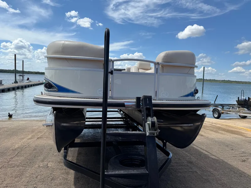 Slide: The Image of 2011 Sun Tracker Regency Party Barge 22 on trailer by a lake under blue sky. - 21