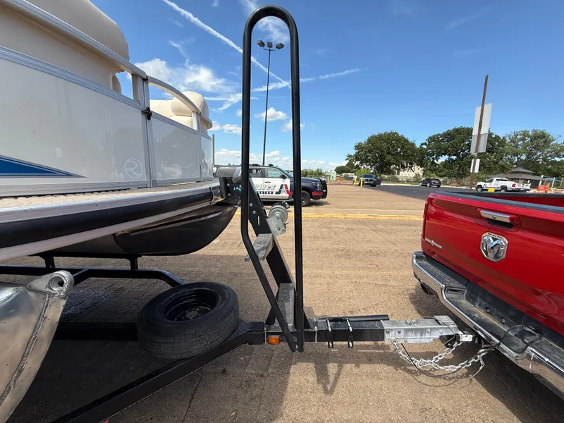 Slide: The Image of 2011 Sun Tracker Regency Party Barge 22 on trailer, showing front view and winch. - 24
