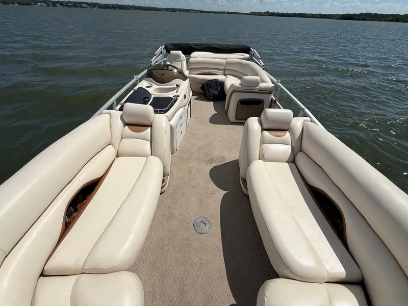 Slide: The Image of 2011 Sun Tracker Regency Party Barge 22 on a lake under a clear blue sky. - 29