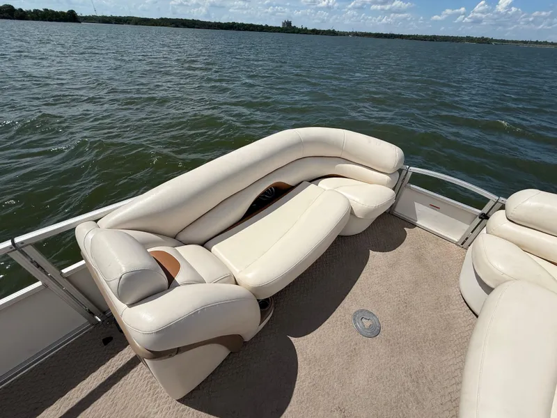 Slide: The Image of 2011 Sun Tracker Regency Party Barge 22 with beige seating on a lake. - 31