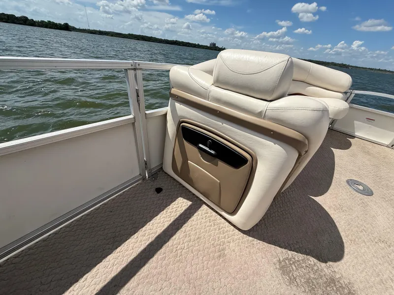 Slide: The Image of 2011 Sun Tracker Regency Party Barge 22 interior with seating, on a sunny day by the water. - 35