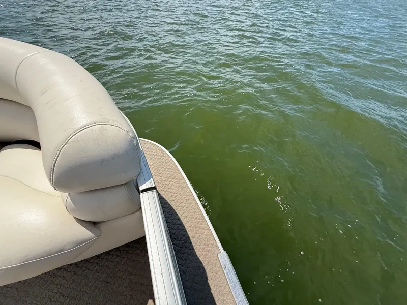 Slide: The Image of 2011 Sun Tracker Regency Party Barge 22 with white seating on a lake. - 37