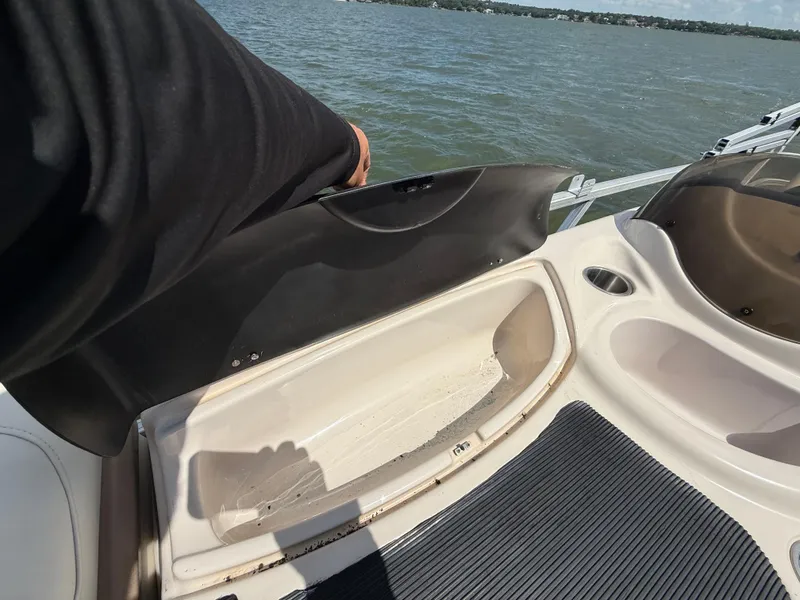 Slide: The Image of 2011 Sun Tracker Regency Party Barge 22 interior with seating and helm on a lake. - 39