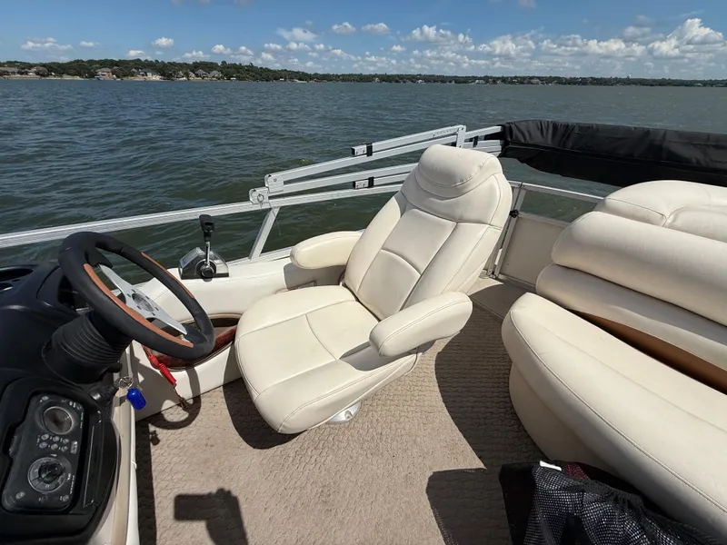 Slide: The Image of 2011 Sun Tracker Regency Party Barge 22 with open storage compartment on a lake. - 40