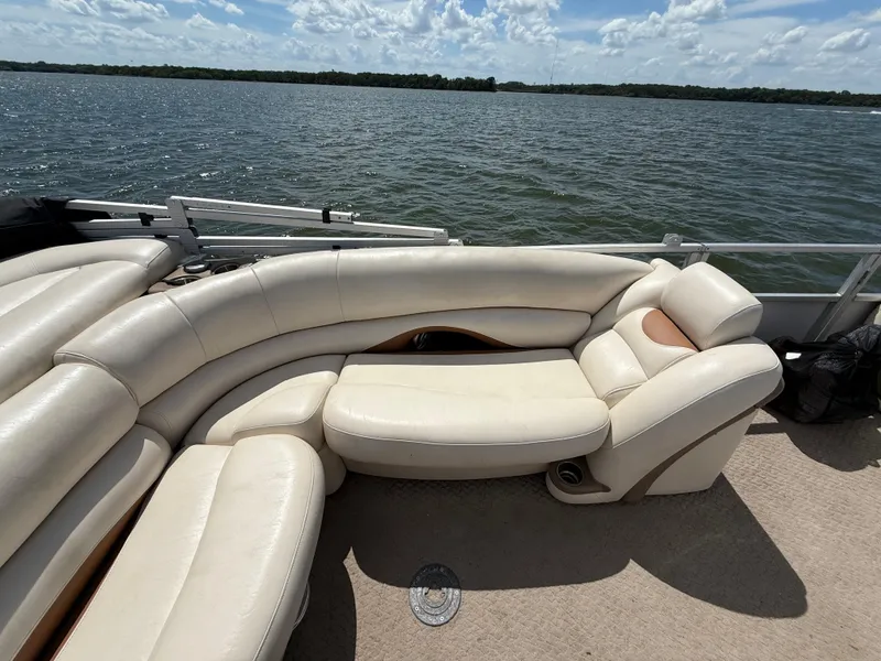 Slide: The Image of 2011 Sun Tracker Regency Party Barge 22 with white seating on a lake. - 46