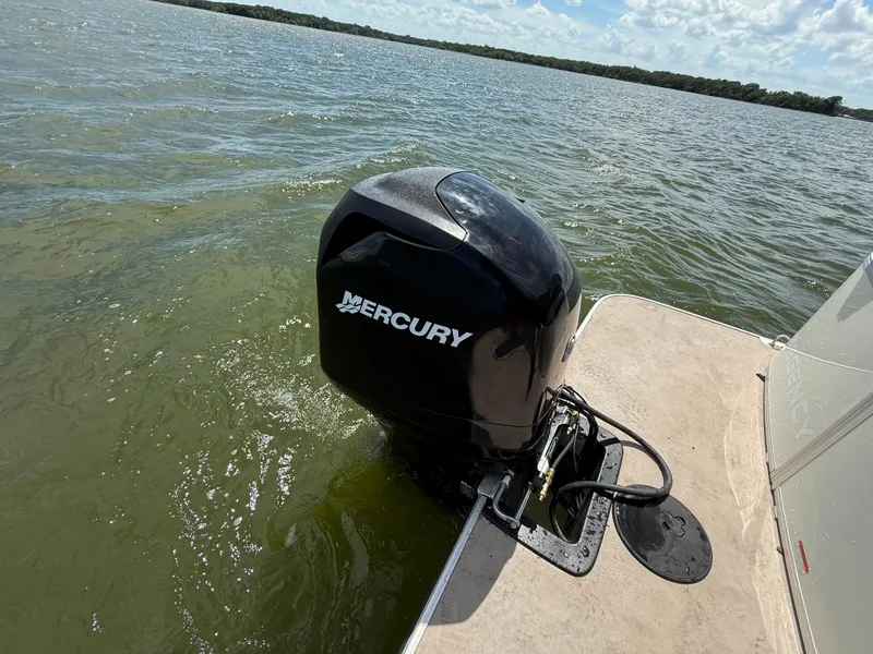 Slide: The Image of 2011 Sun Tracker Regency Party Barge 22 on a lake, featuring white seating and railing. - 49