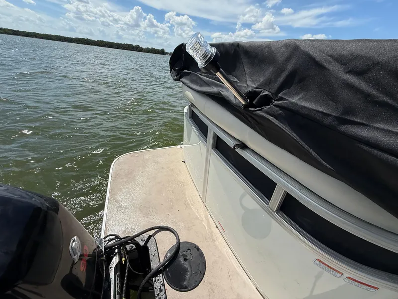Slide: The Image of 2011 Sun Tracker Regency Party Barge 22 with Mercury outboard on a lake. - 50