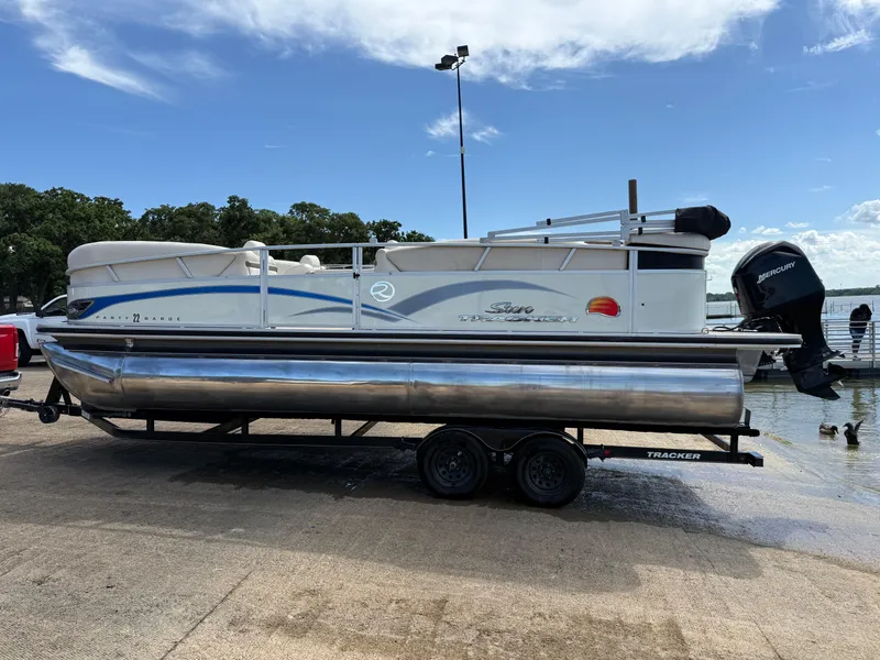 Slide: The Image of 2011 Sun Tracker Regency Party Barge 22 pontoon boat on trailer by a lake. - 6